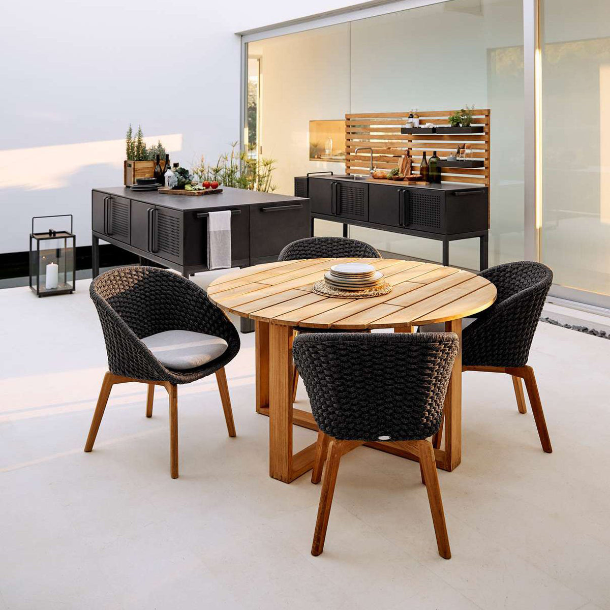 Endless Dining Table by Cane-Line, showing endless dining table with chairs in live shot.