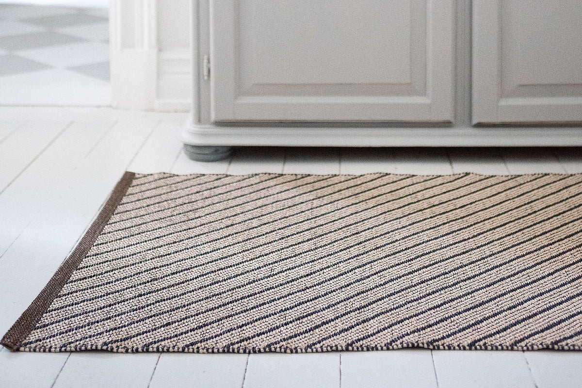 Ester Woven Plastic Rug by Brita, showing closeup view of easter woven plastic rug in live shot.