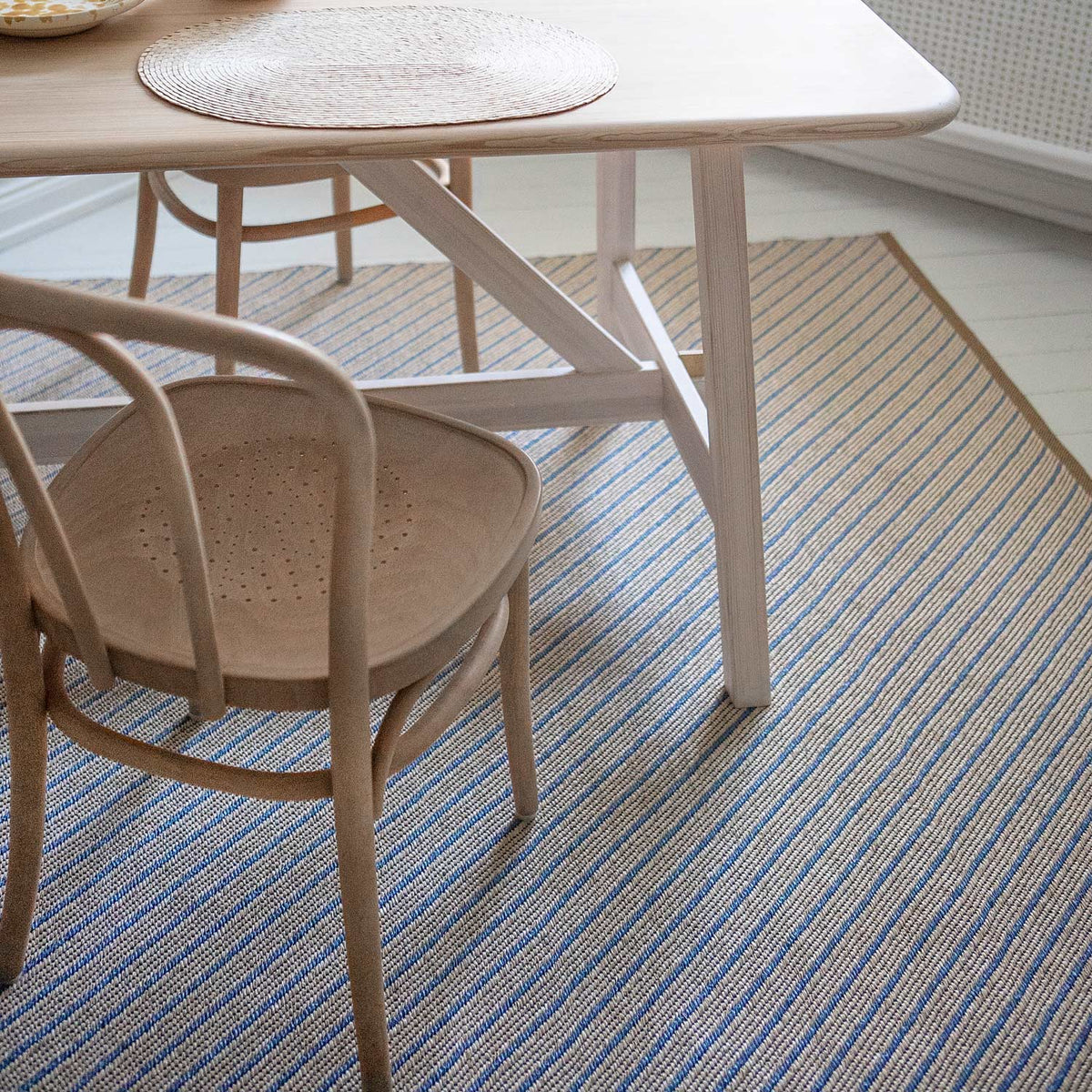 Ester Woven Plastic Rug by Brita, showing closeup view of easter woven plastic rug in live shot.