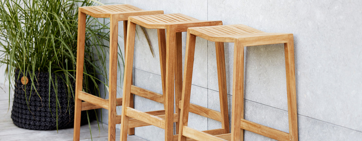 Flip Bar Chair by Cane-Line, showing flip bar chairs in live shot.