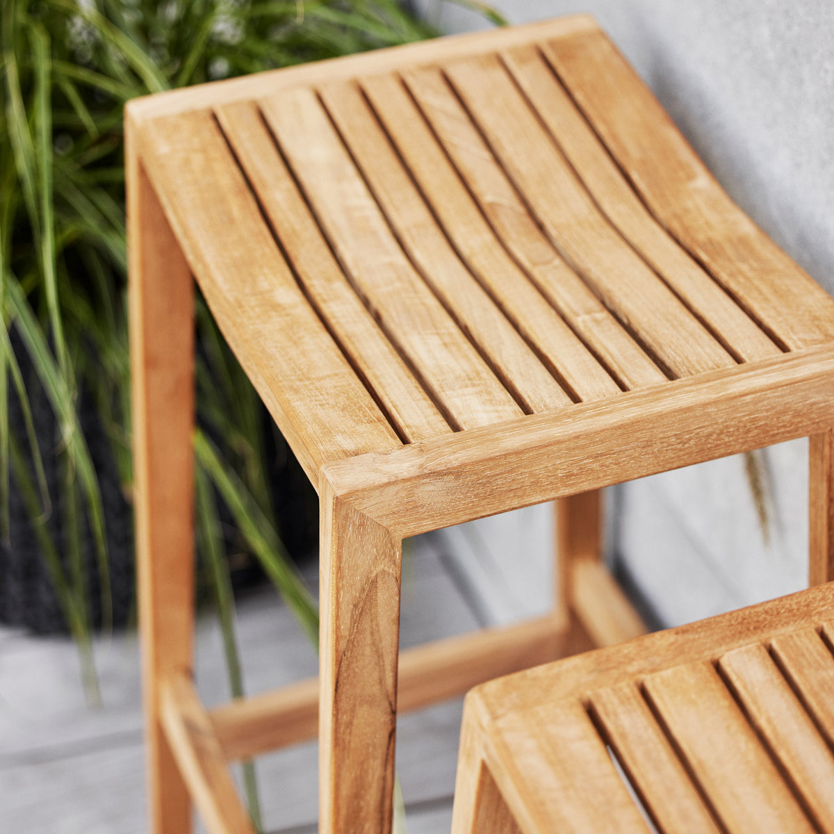 Flip Bar Chair by Cane-Line, showing closeup view of flip bar chairs in live shot.