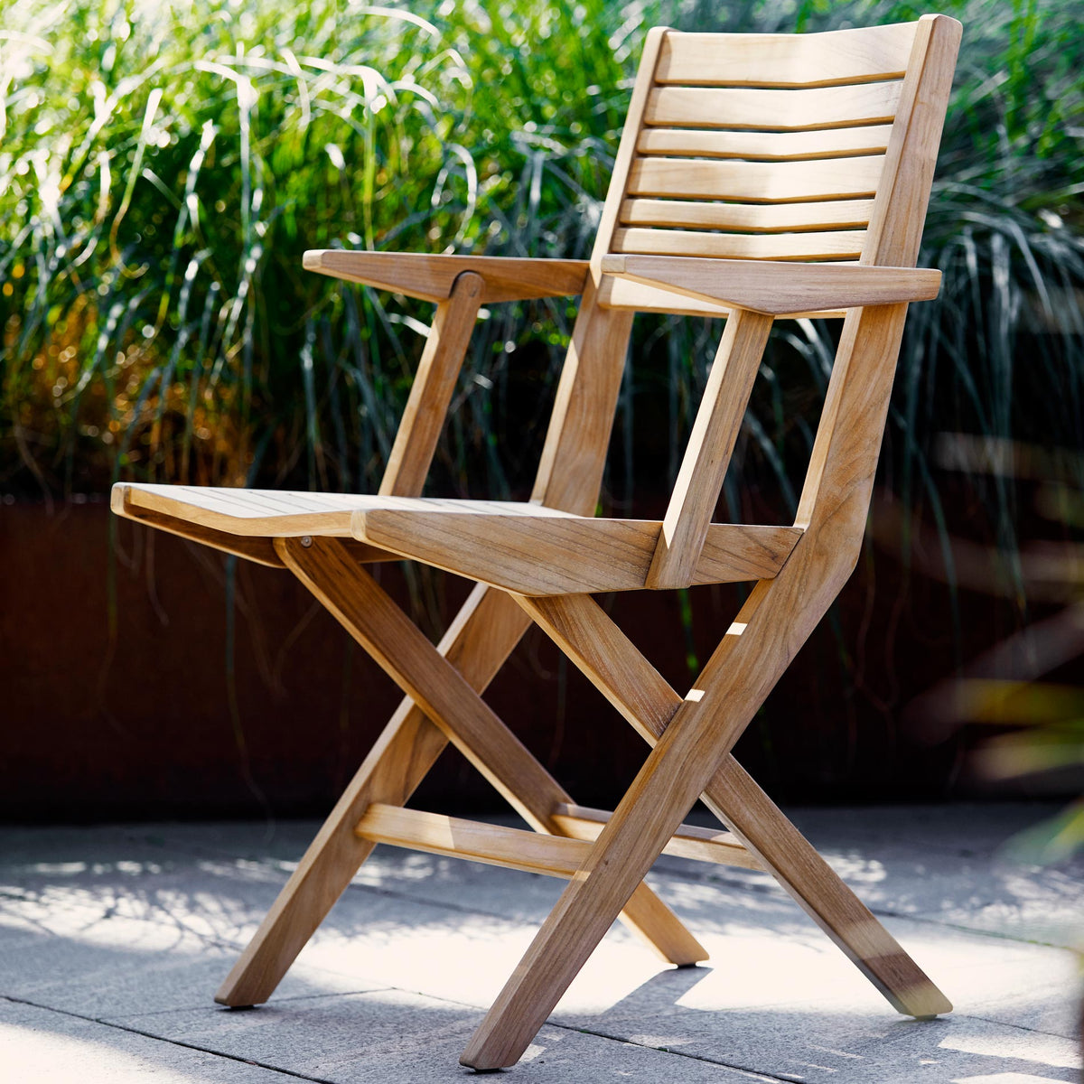 Flip Folding Teak Dining Armchair by Cane-Line, showing flip folding teak dining armchair in live shot.