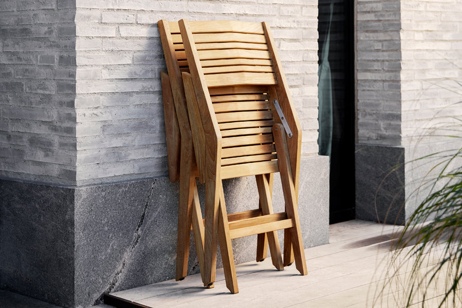 Flip Folding Teak Dining Armchair by Cane-Line, showing flip folding teak dining armchairs in live shot.