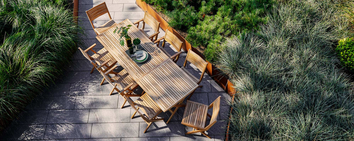 Flip Folding Teak Dining Chair by Cane-Line, showing flip folding teak dining chairs with dining tables in live shot.