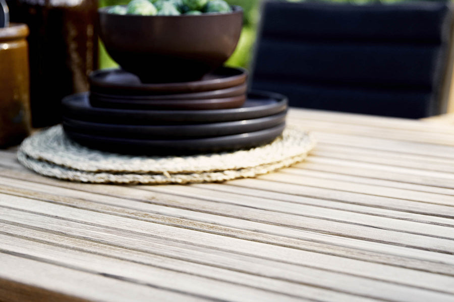 Flip Folding Teak Dining Table by Cane-Line, showing closeup view of flip folding teak dining table in live shot.