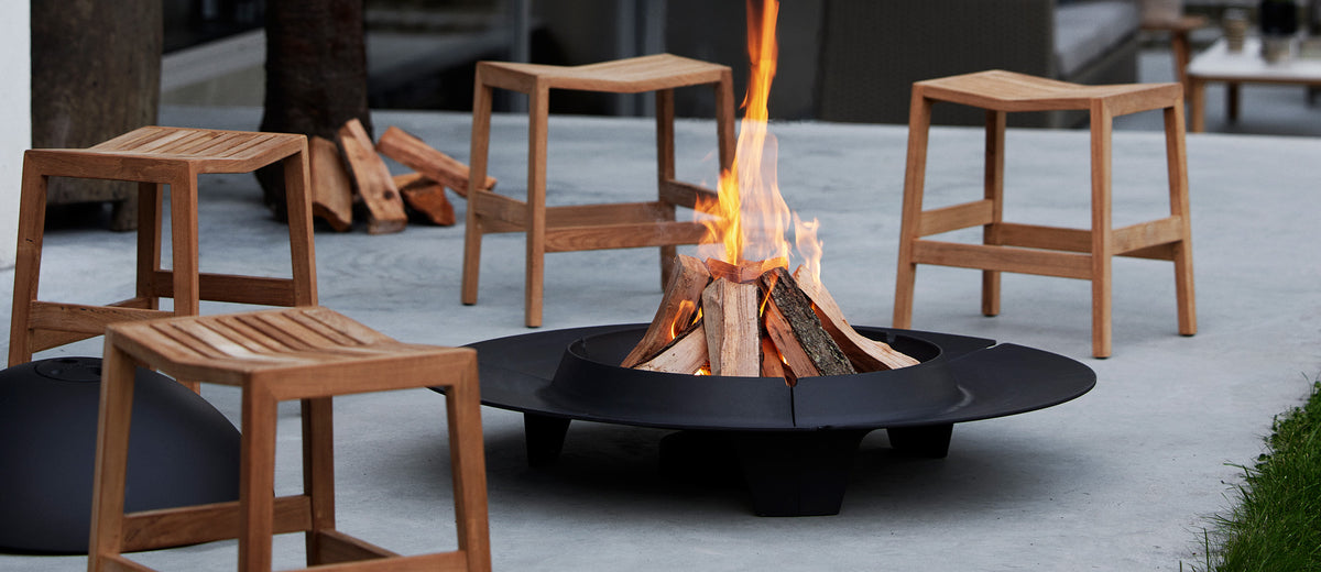 Flip Stool by Cane-Line, showing flip stools in live shot.