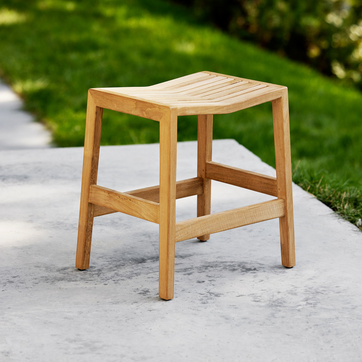 Flip Stool by Cane-Line, showing flip stool in live shot.