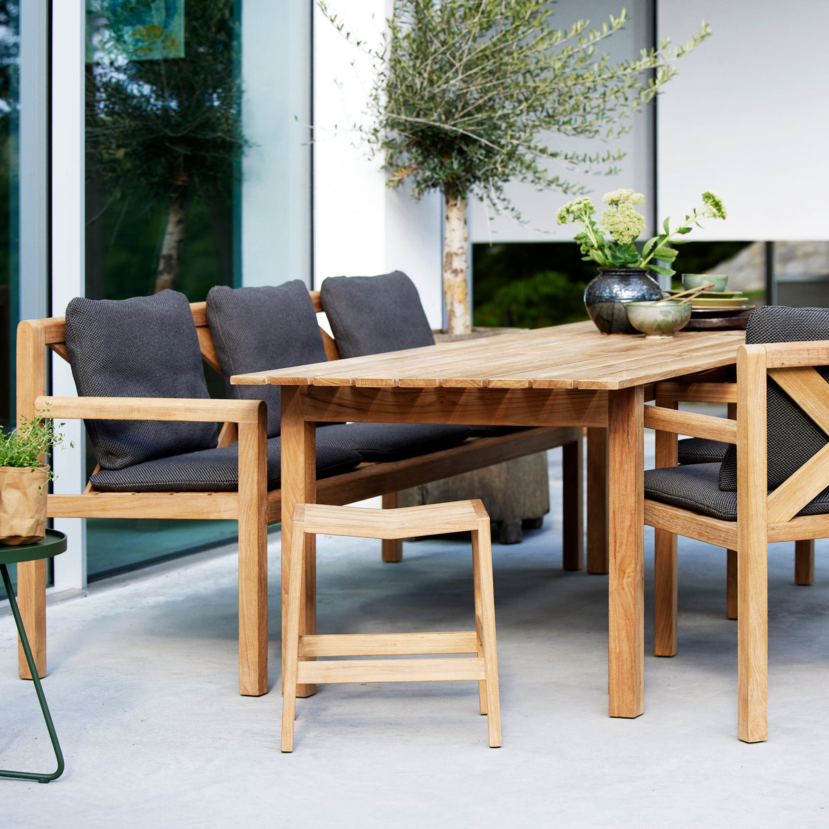 Flip Stool by Cane-Line, showing flip stool in live shot.