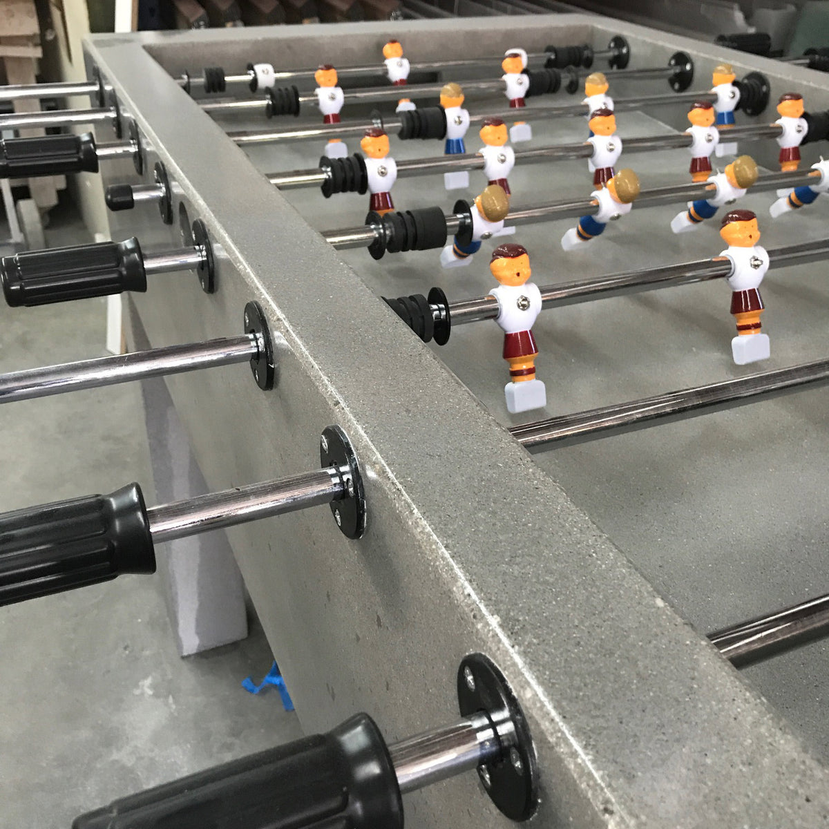 James De Wulf Foosball Table by De Wulf, showing closeup view of foosball table in live shot.
