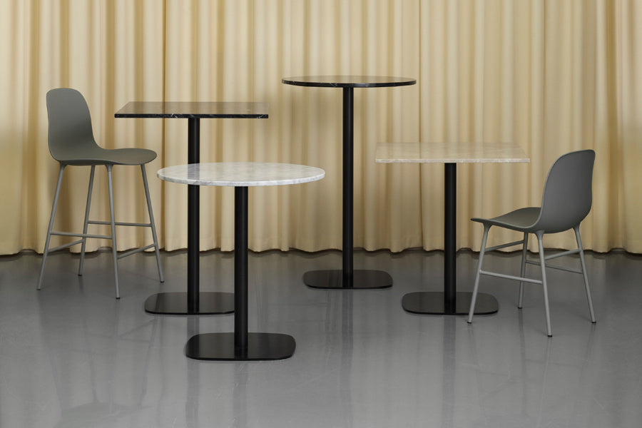 Form Cafe Table by Normann Copenhagen, showing form cafe tables in live shot.