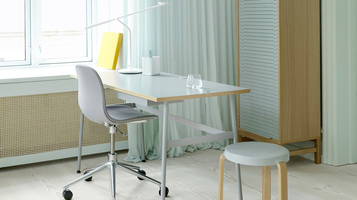 Form Swivel Gaslift Office Chair by Normann Copenhagen, showing form swivel gaslift office chair with table in live shot.