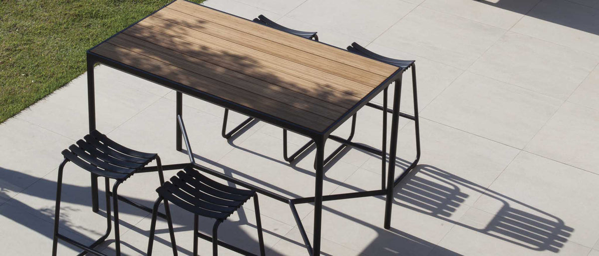 Four Outdoor Bar Table by Houe, showing four outdoor bar table with bar stools in live shot.
