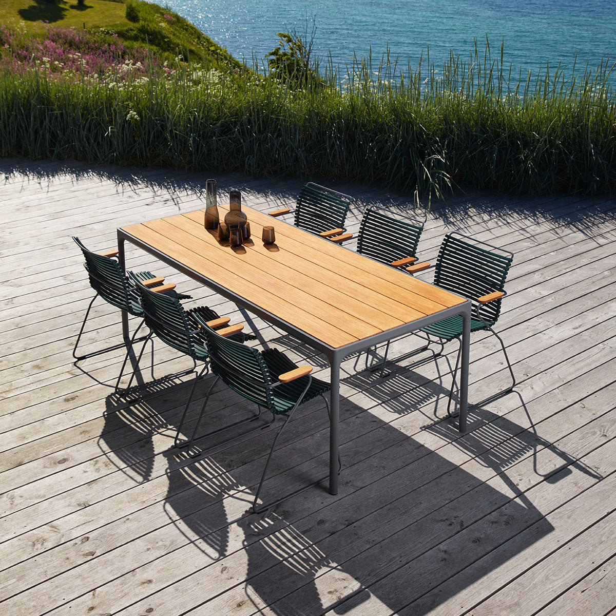 Four Outdoor Dining Table by Houe, showing four outdoor dining table with chairs in live shot.