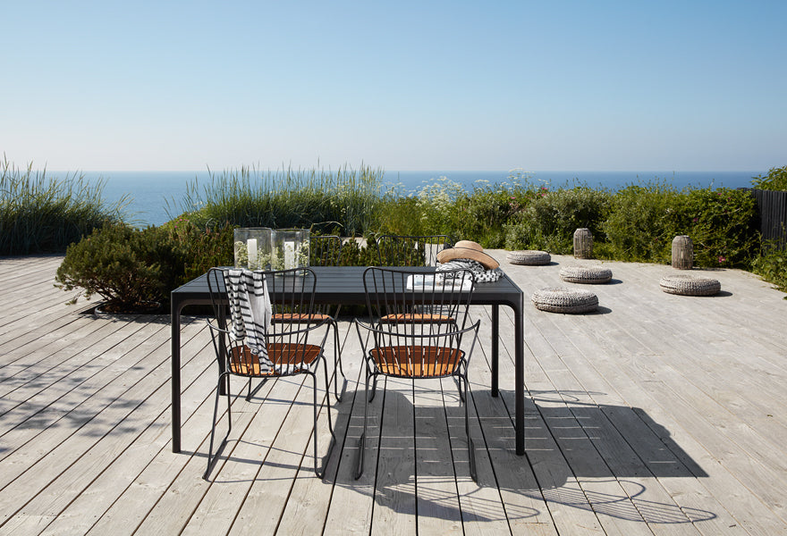 Four Outdoor Dining Table by Houe, showing four outdoor dining table with chairs in live shot.