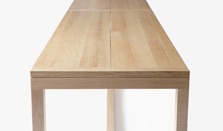 Frame Dining Table by Nikari, showing side view of frame dining table in 142" wide/oak.