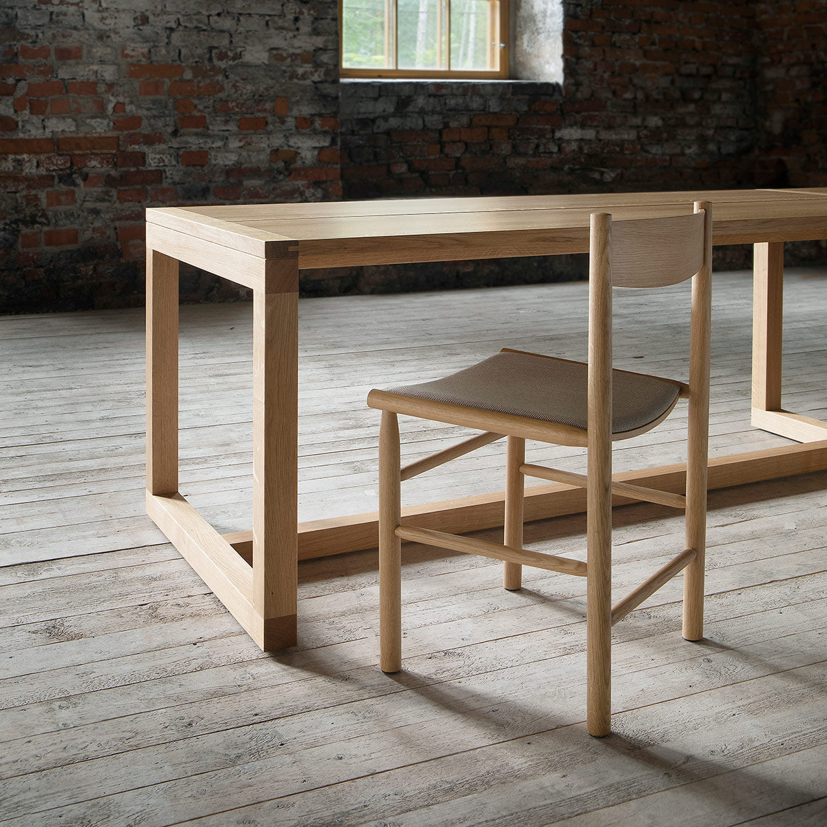 Frame Dining Table by Nikari, showing closeup view of frame dining table in live shot.