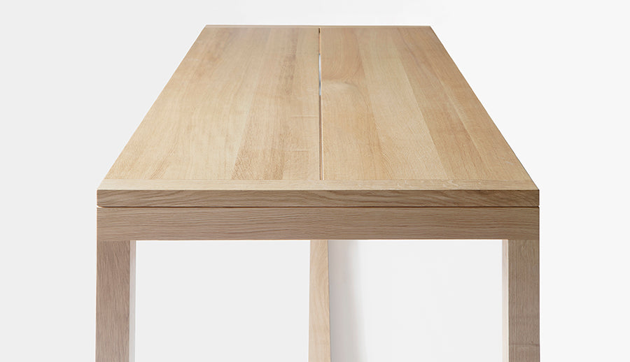 Frame Dining Table by Nikari, showing side view of frame dining table in 79" wide/oak.