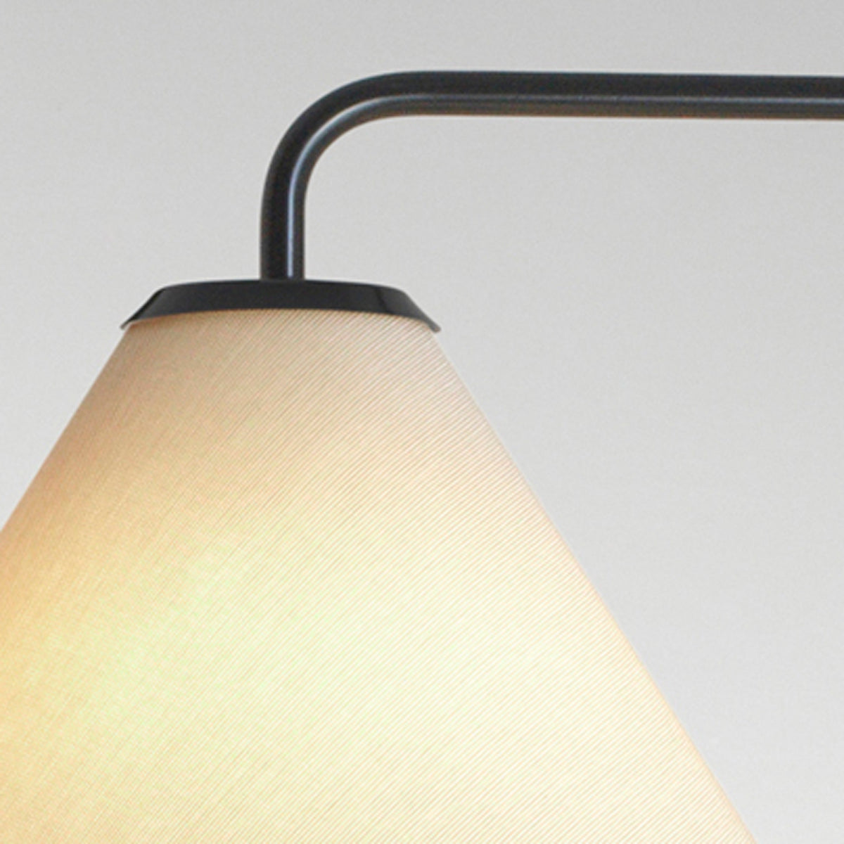 Funiculi A Fabric Wall Lamp by Marset, showing closeup view of funiculi a fabric wall lamp in sand fabric shade.