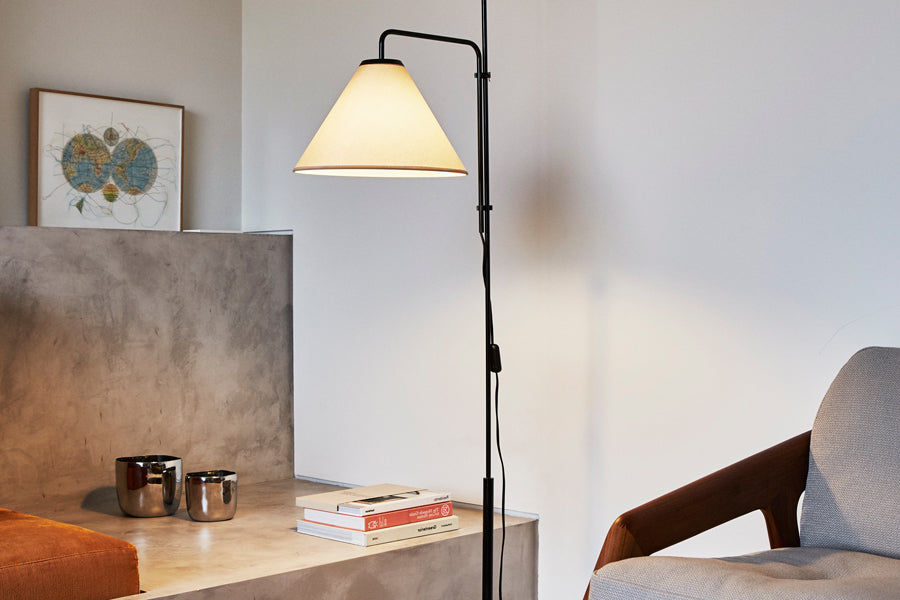 Funiculi Fabric Floor Lamp by Marset, showing funiculi fabric floor lamp with chair in live shot.