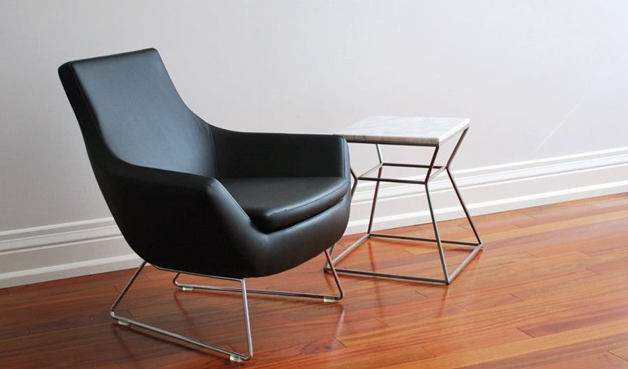 Gakko End Table by sohoConcept, showing side view of the chair with table.