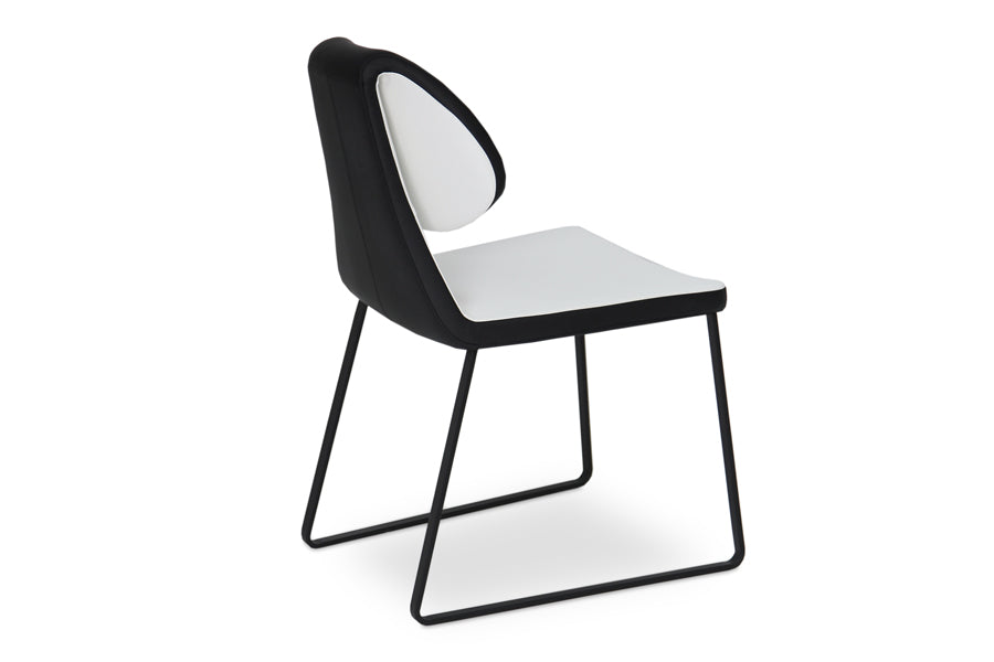 Gakko Slide Dining Chair by SohoConcept, showing angle view of gakko sled dining chair in black & white leatherette with black powder base.