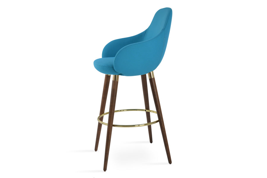 Gazel Arm Wood Stools by SohoConcept, showing angle view in camira era turquoise wool with beech wood walnut base (gold ring and gold bracelet).