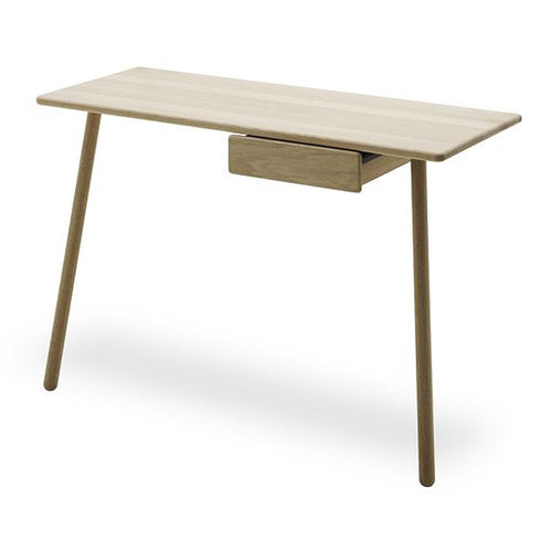 Georg Leaning Desk by Skagerak, showing angle view of georg leaning desk in oak with georg drawer.