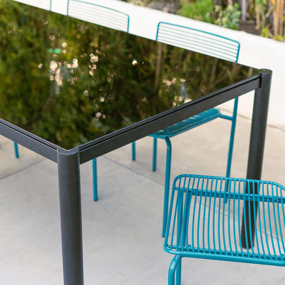Get Together Table by Bend, showing closeup view of get together table with chairs in live shot.