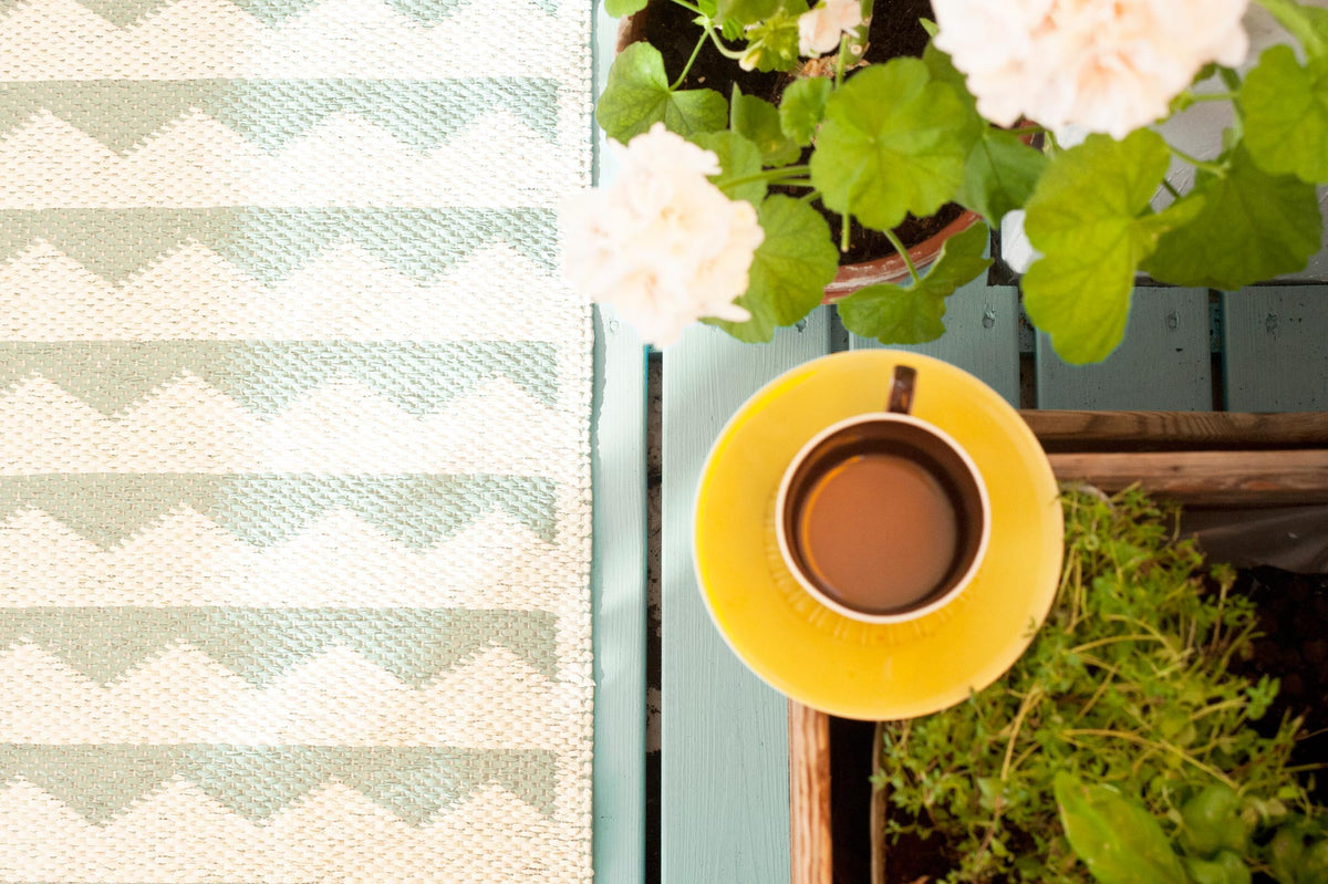 Gittan Woven Plastic Rug by Brita, showing closeup view of gittan woven plastic rug in live shot.