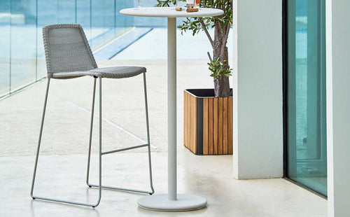 Go Bar Table by Cane-Line, showing go bar table with chair in live shot.