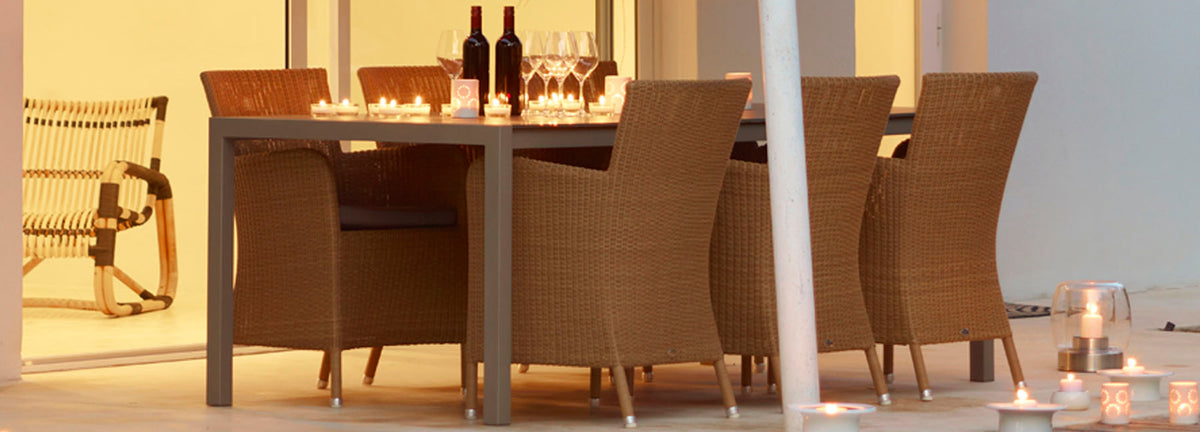 Hampsted Outdoor Dining Chair by Cane-Line, showing hampsted outdoor dining chairs with table in live shot.