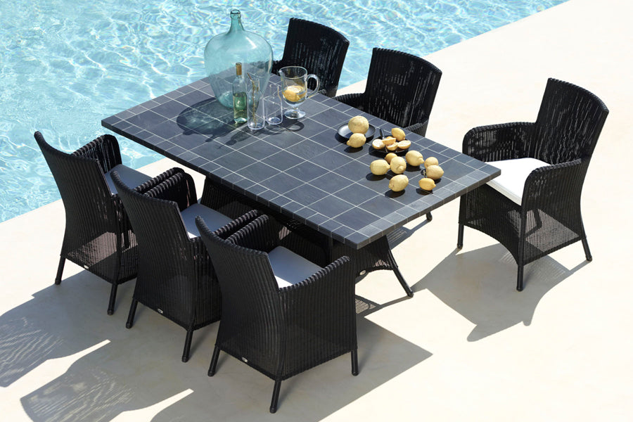 Hampsted Outdoor Dining Chair by Cane-Line, showing hampsted outdoor dining chairs with table in live shot.