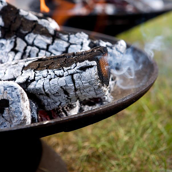 Helios Outdoor Firebowl by Skagerak, showing closeup view of helios outdoor firebowl in live shot.