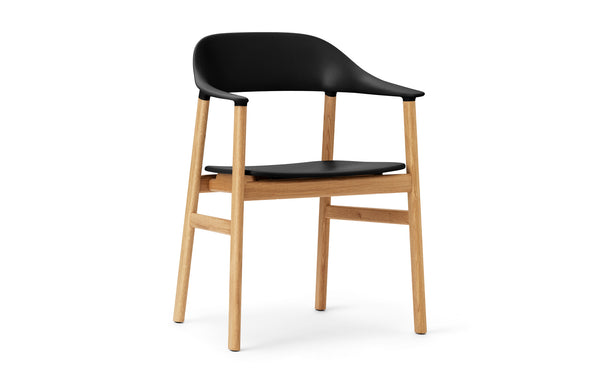 Herit Armchair by Normann Copenhagen - Oak Wood Legs, Black Plastic Shell Seat.
