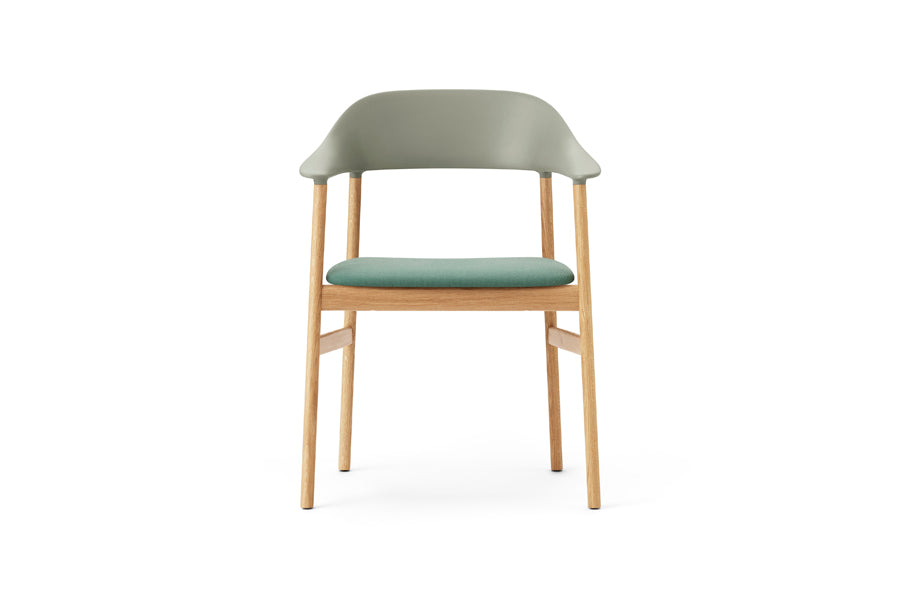 Herit Upholstery Armchair by Normann Copenhagen, showing front view of herit upholstery armchair in oak wood legs/dusty green synergy fabric seat.