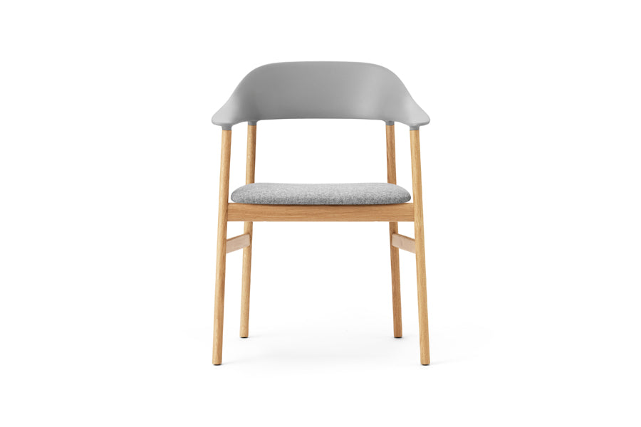 Herit Upholstery Armchair by Normann Copenhagen, showing front view of herit upholstery armchair in oak wood legs/grey synergy fabric seat.