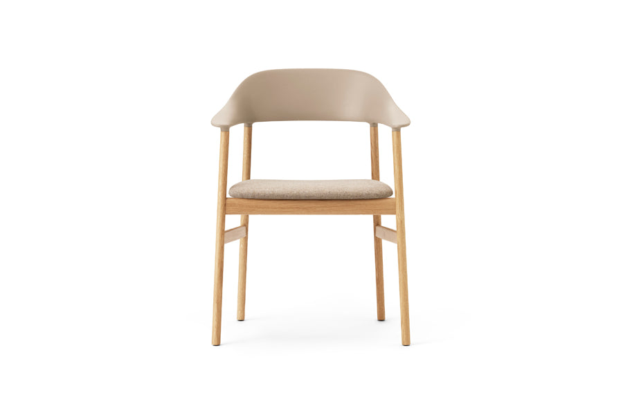Herit Upholstery Armchair by Normann Copenhagen, showing front view of herit upholstery armchair in oak wood legs/sand synergy fabric seat.