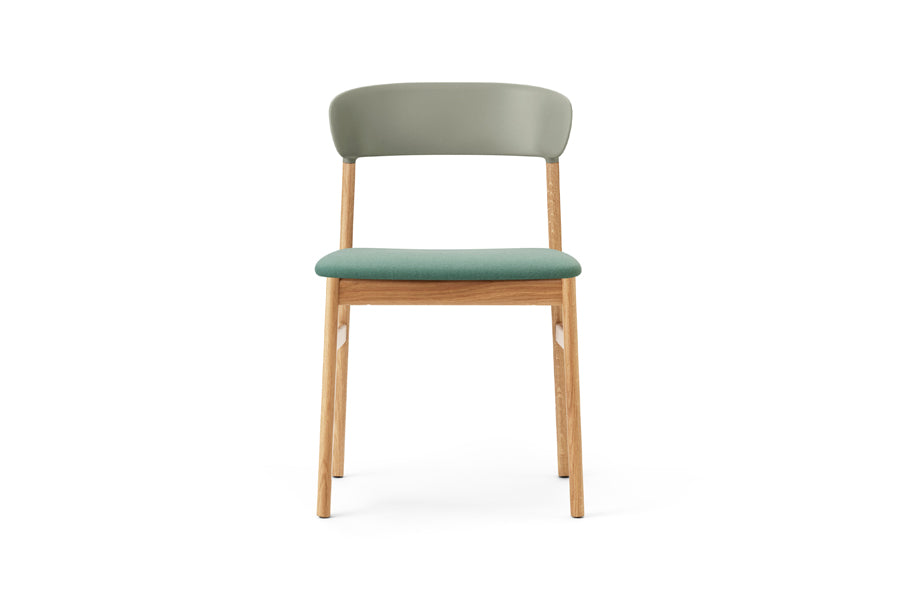 Herit Upholstery Chair by Normann Copenhagen, showing front view of herit upholstery chair in oak wood legs/dusty green synergy fabric seat.