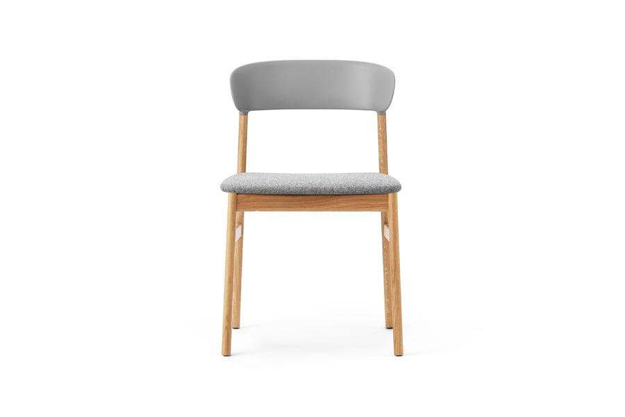 Herit Upholstery Chair by Normann Copenhagen, showing front view of herit upholstery chair in oak wood legs/grey synergy fabric seat.