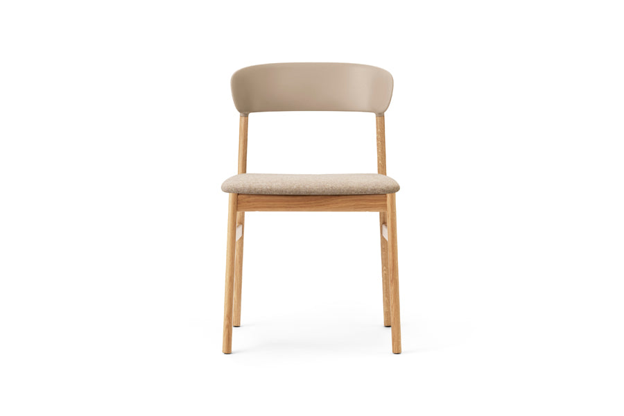 Herit Upholstery Chair by Normann Copenhagen, showing front view of herit upholstery chair in oak wood legs/sand synergy fabric seat.