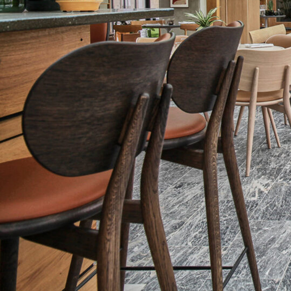 High Stool with Backrest by Mater, showing closeup view of high stools with backrests in live shot.