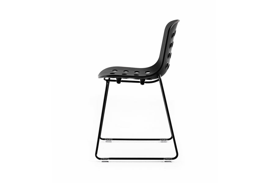 Holi Sled Base Side Chair by Toou, showing side view of holi sled base side chair in open shell/black.