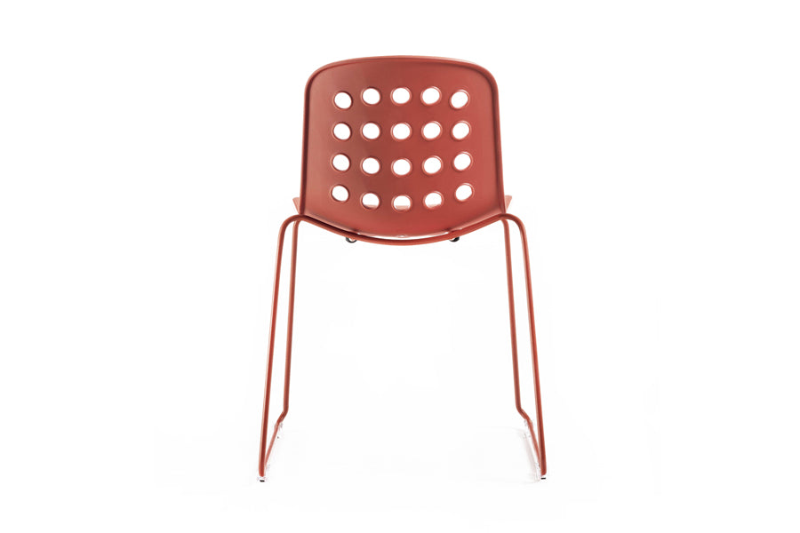 Holi Sled Base Side Chair by Toou, showing back view of holi sled base side chair in open shell/red terracotta.