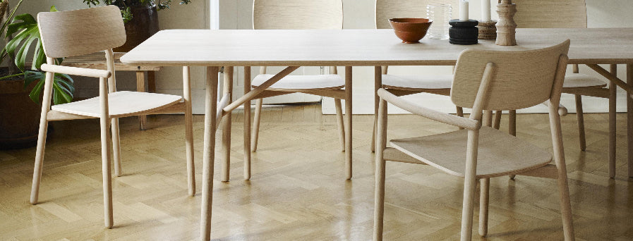 Hven Armchair by Skagerak, showing hven armchairs with table in live shot.