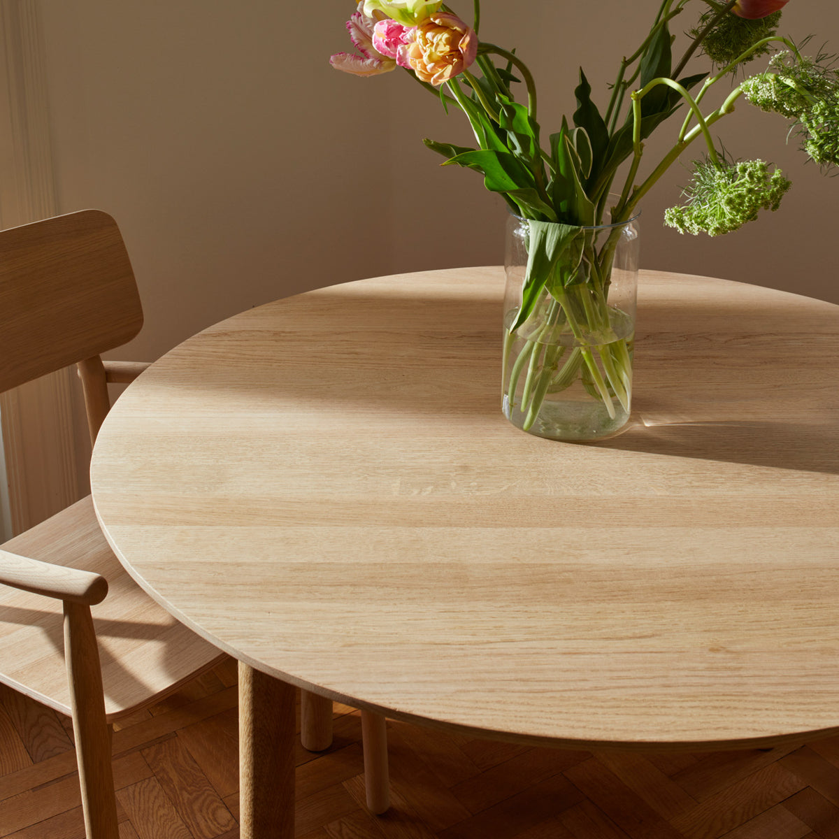 Hven Table by Skagerak, showing closeup view of hven table with chair in live shot.