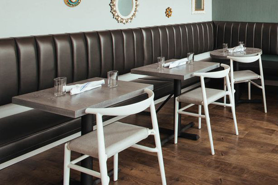 JOI Dining Chair by Toou, showing joi dining chairs with dining tables in live shot.