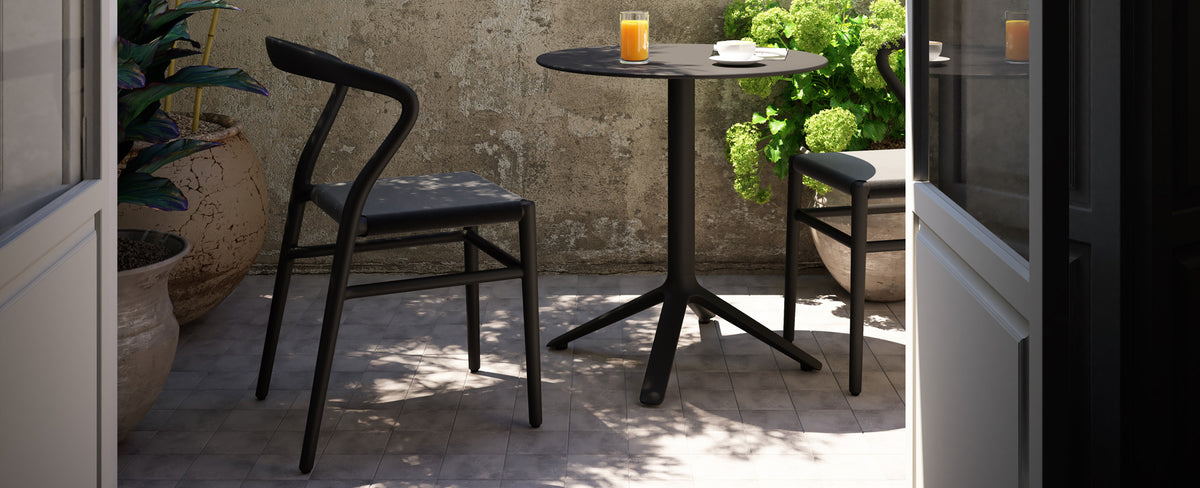 JOI Dining Chair by Toou, showing joi dining chairs with dining table in live shot.