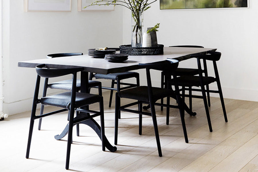 JOI Dining Chair by Toou, showing joi dining chairs with dining table in live shot.