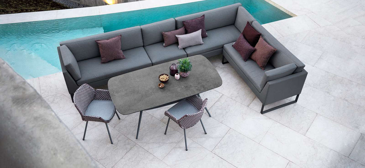 Joy Outdoor Oval Dining Table by Cane-Line, showing joy outdoor oval dining table in live shot.