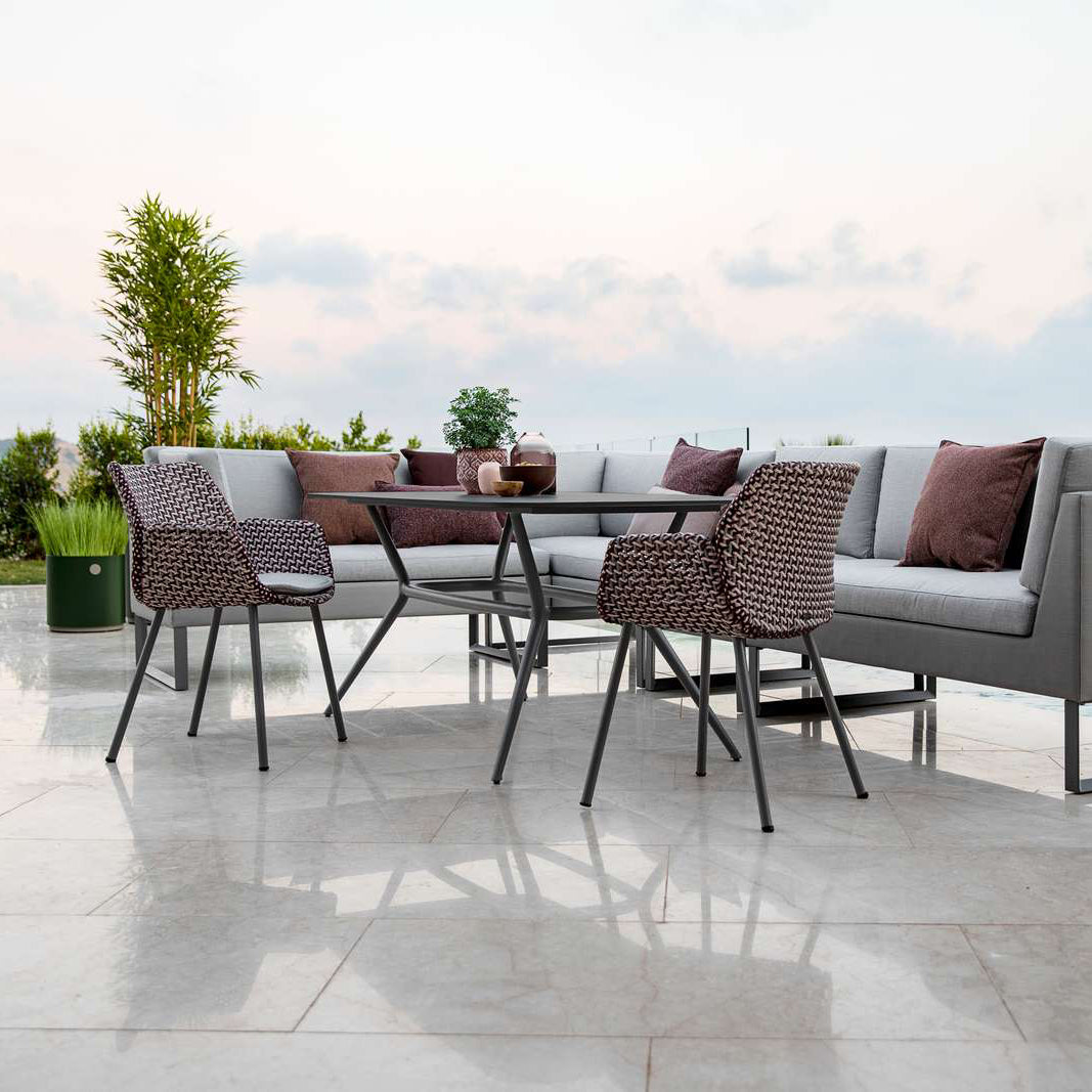 Joy Outdoor Oval Dining Table by Cane-Line, showing joy outdoor oval dining table in live shot.